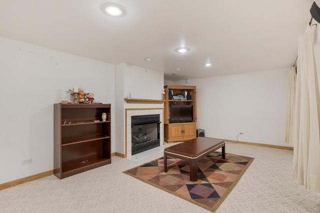 living room featuring baseboards, recessed lighting, light colored carpet, and a tile fireplace
