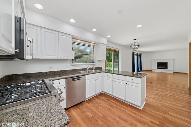 600 N Brookdale Dr, Schaumburg, IL 60194 - kitchen with stainless steel appliances, a peninsula, light wood-style flooring, white cabinets, and open floor plan