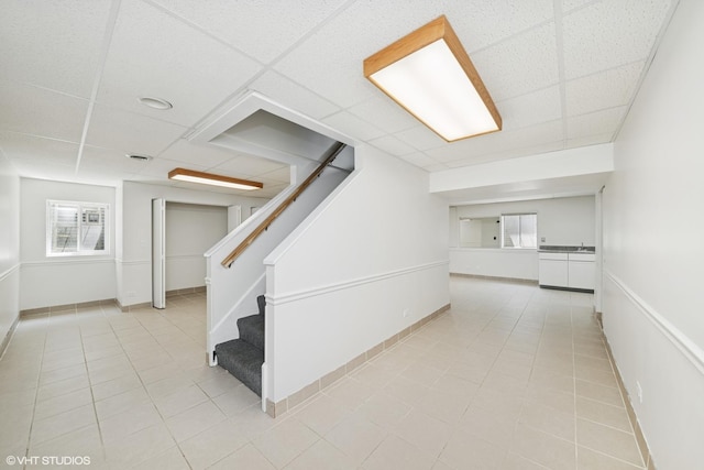 600 N Brookdale Dr, Schaumburg, IL 60194 - corridor with a paneled ceiling, light tile patterned floors, and stairway
