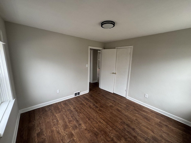 corridor with dark wood-type flooring