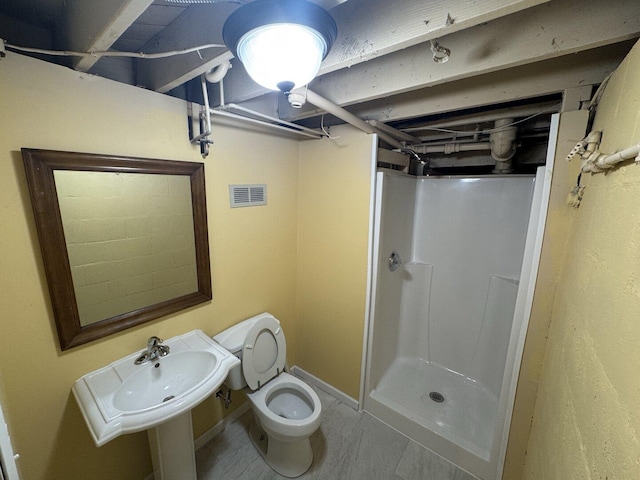 basement featuring concrete block wall and electric panel