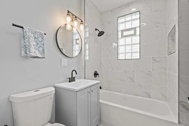 bathroom featuring toilet, vanity, and shower / bathing tub combination