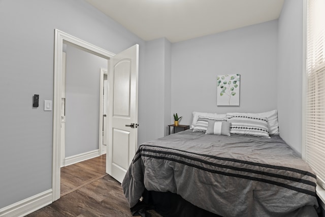 bedroom featuring dark wood-type flooring and baseboards