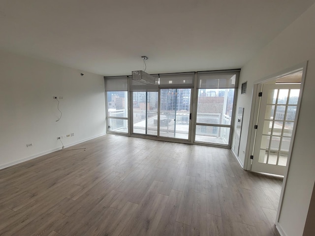 757 N Orleans St Unit 1004, Chicago, IL 60654 - unfurnished dining area with wood finished floors, plenty of natural light, baseboards, and floor to ceiling windows