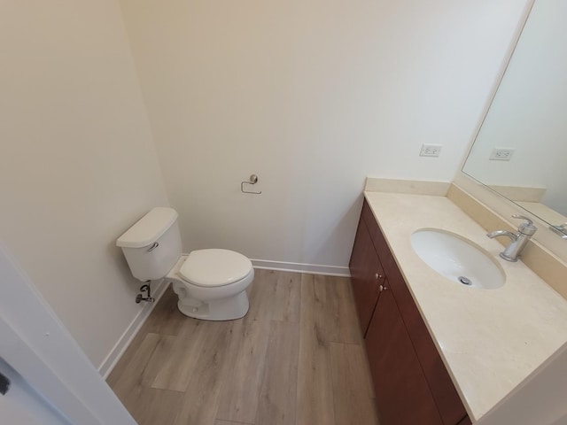 757 N Orleans St Unit 1004, Chicago, IL 60654 - half bath featuring toilet, wood finished floors, vanity, and baseboards