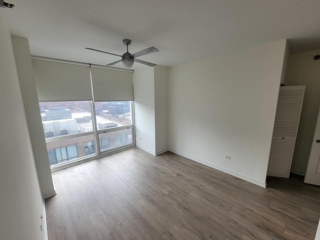 757 N Orleans St Unit 1004, Chicago, IL 60654 - empty room with ceiling fan, wood finished floors, and baseboards