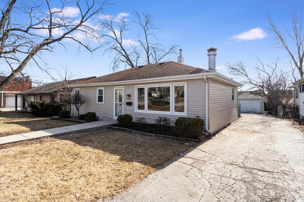 7219 W 113th Pl, Worth, IL 60482 - view of front of home featuring an outdoor structure, a shingled roof, and a garage