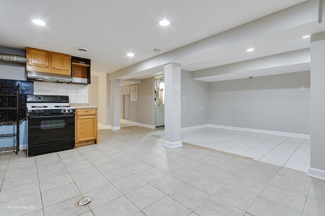 kitchen featuring light tile patterned floors, light countertops, under cabinet range hood, recessed lighting, and gas range oven