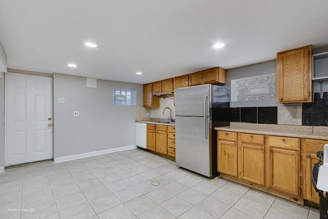 kitchen with freestanding refrigerator, light countertops, dishwasher, and recessed lighting