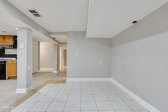 interior space with visible vents, baseboards, and light tile patterned floors