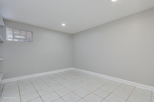 empty room featuring light tile patterned floors, baseboards, and recessed lighting