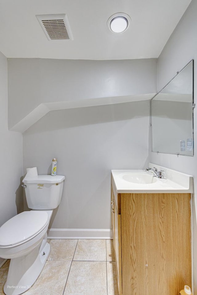 bathroom featuring vanity, baseboards, tile patterned floors, toilet, and visible vents