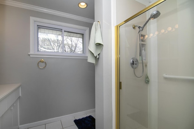full bathroom featuring a shower stall, baseboards, crown molding, and tile patterned flooring