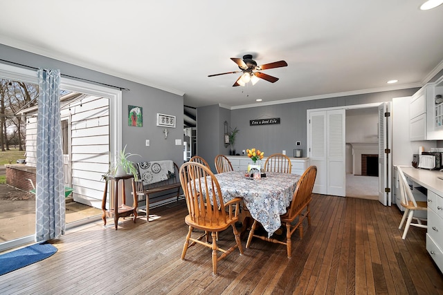 dining area with dark wood finished floors, ceiling fan, ornamental molding, and recessed lighting