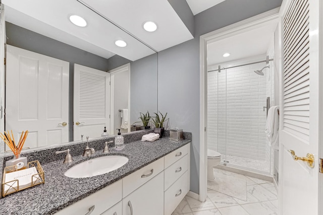 full bath with vanity, marble finish floor, toilet, recessed lighting, and a stall shower