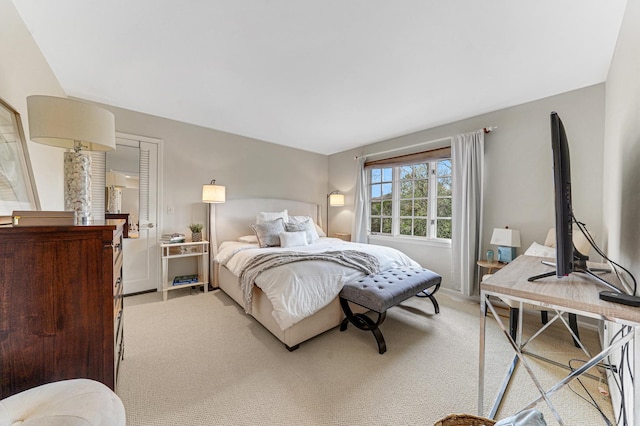bedroom featuring baseboards and light colored carpet