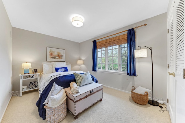 carpeted bedroom featuring baseboards