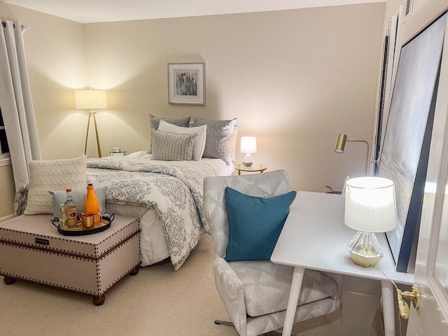 bedroom with visible vents and light colored carpet