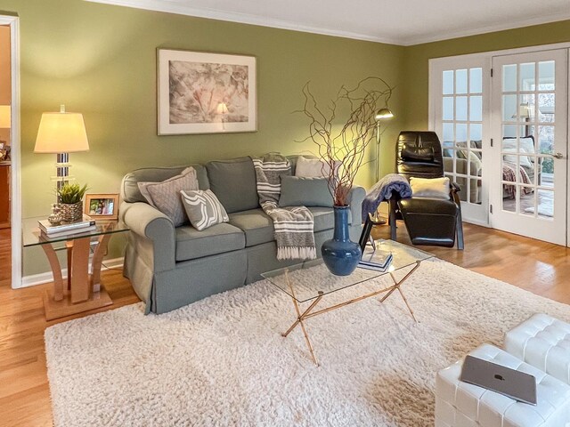 living area with ornamental molding, baseboards, french doors, and wood finished floors