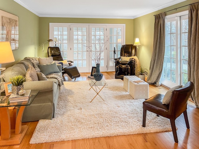 living area with french doors, crown molding, and wood finished floors