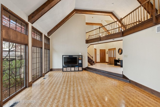 unfurnished living room featuring visible vents, stairs, beam ceiling, baseboards, and high vaulted ceiling