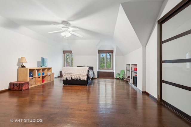 bedroom featuring baseboards, vaulted ceiling, and wood finished floors