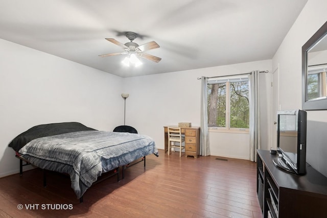 bedroom with a ceiling fan, hardwood / wood-style floors, and visible vents