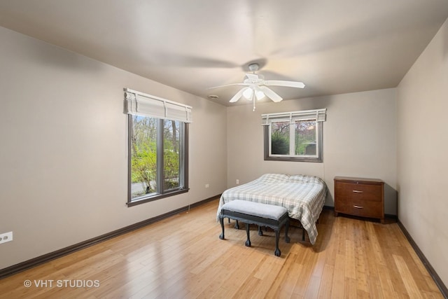 bedroom with baseboards, a ceiling fan, and light wood finished floors