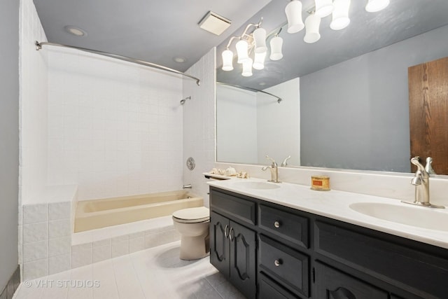 full bathroom featuring a sink, tile patterned flooring, bathtub / shower combination, double vanity, and toilet