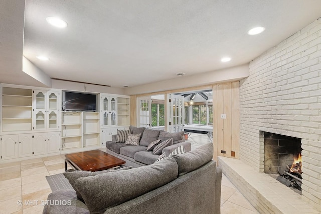 living area with a fireplace, recessed lighting, and light tile patterned flooring