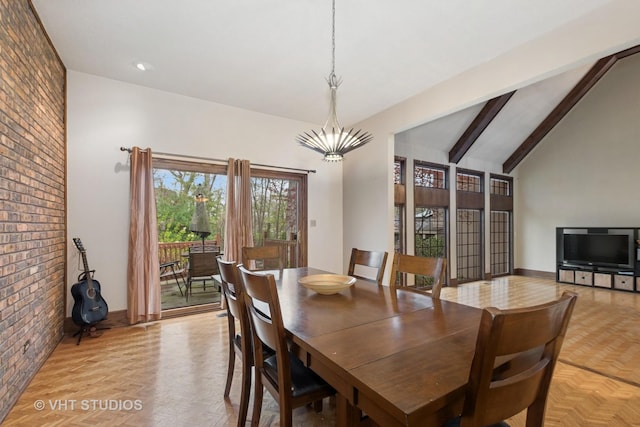 dining area featuring vaulted ceiling with beams, a notable chandelier, and brick wall