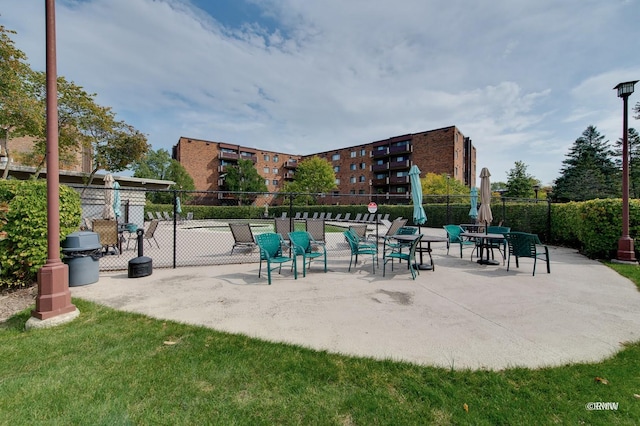 view of property's community with a patio area and fence
