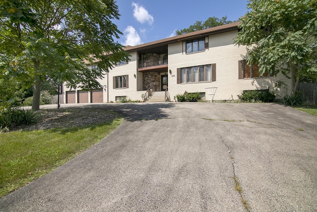 8850 W 101st Pl, Palos Hills, IL 60465 - view of front of house with a garage, aphalt driveway, and brick siding
