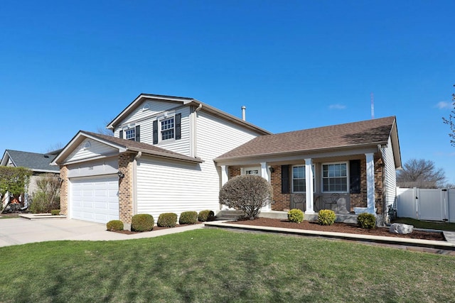 view of front of house featuring an attached garage, a gate, concrete driveway, a front lawn, and brick siding