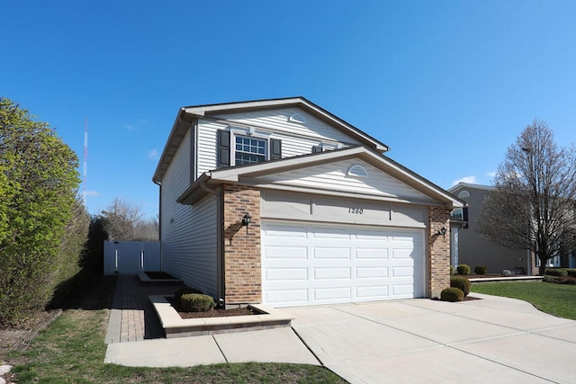 view of front of house with concrete driveway and brick siding