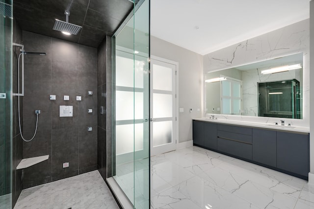 full bath featuring a sink, a tile shower, double vanity, french doors, and marble finish floor