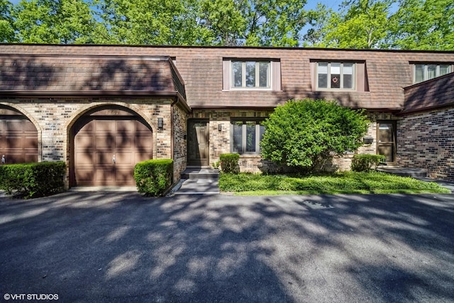 1767 Jefferson Ave, Glenview, IL 60025 - view of front of property featuring brick siding, a garage, mansard roof, and driveway