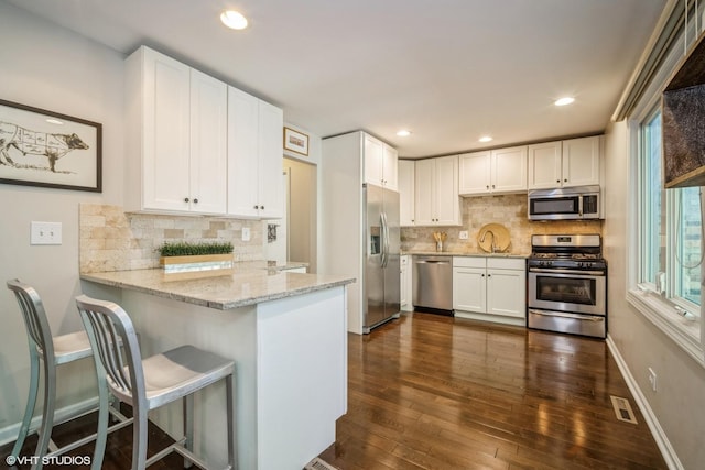 1767 Jefferson Ave, Glenview, IL 60025 - kitchen with tasteful backsplash, appliances with stainless steel finishes, a peninsula, and white cabinets
