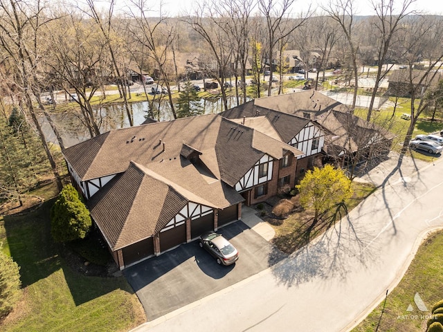 birds eye view of property featuring a water view and a residential view