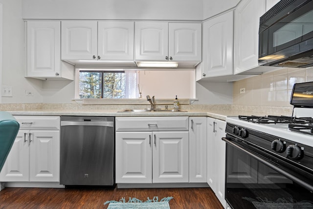 kitchen with stainless steel dishwasher, black microwave, white cabinetry, a sink, and gas range oven