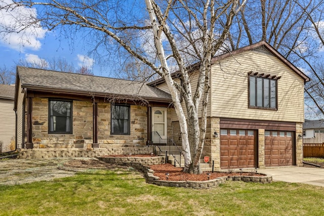 1097 Washington St, Bartlett, IL 60103 - tri-level home featuring stone siding, concrete driveway, an attached garage, and a shingled roof