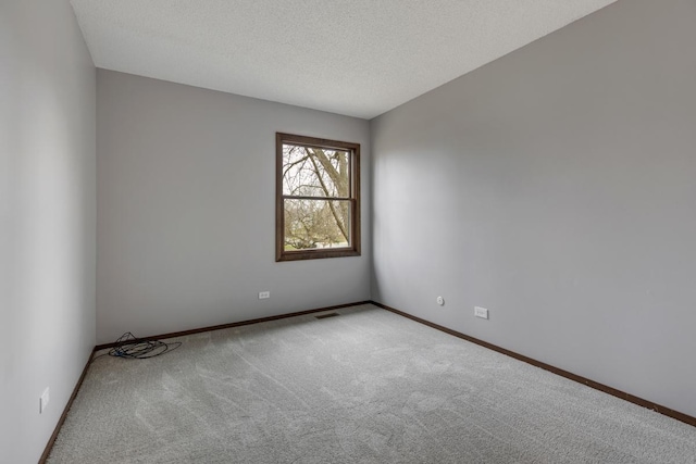 1097 Washington St, Bartlett, IL 60103 - carpeted empty room with baseboards and a textured ceiling