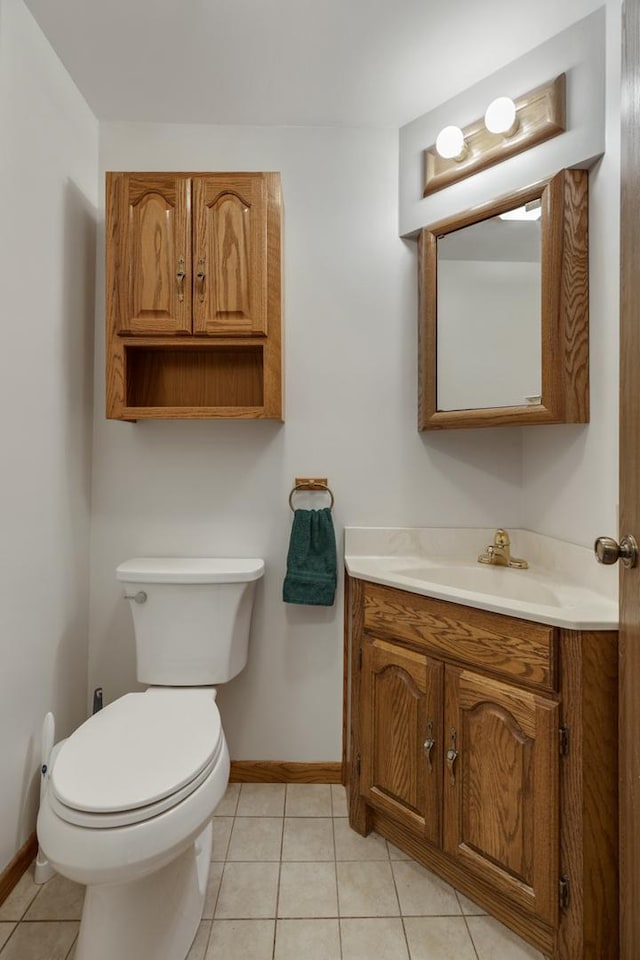 1097 Washington St, Bartlett, IL 60103 - bathroom with baseboards, toilet, tile patterned flooring, and vanity