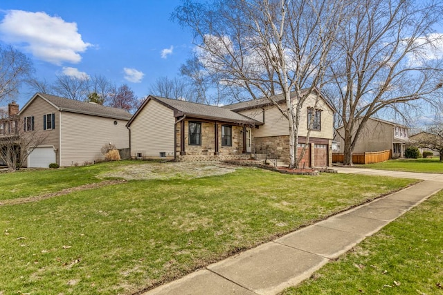 1097 Washington St, Bartlett, IL 60103 - split level home with an attached garage, concrete driveway, a front lawn, and stone siding
