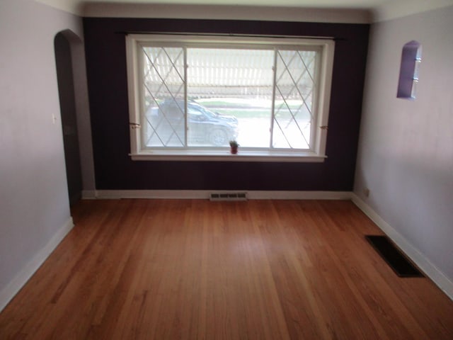3805 Euclid Ave, Berwyn, IL 60402 - spare room with arched walkways, light wood finished floors, and baseboards