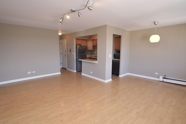 1227 S Harlem Ave Unit 511, Berwyn, IL 60402 - unfurnished living room with a baseboard heating unit, light wood finished floors, and baseboards