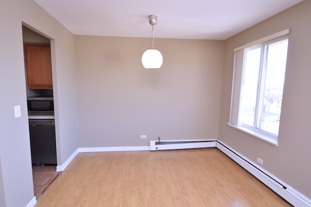 1227 S Harlem Ave Unit 511, Berwyn, IL 60402 - unfurnished dining area with plenty of natural light, light wood-type flooring, baseboard heating, and a baseboard heating unit