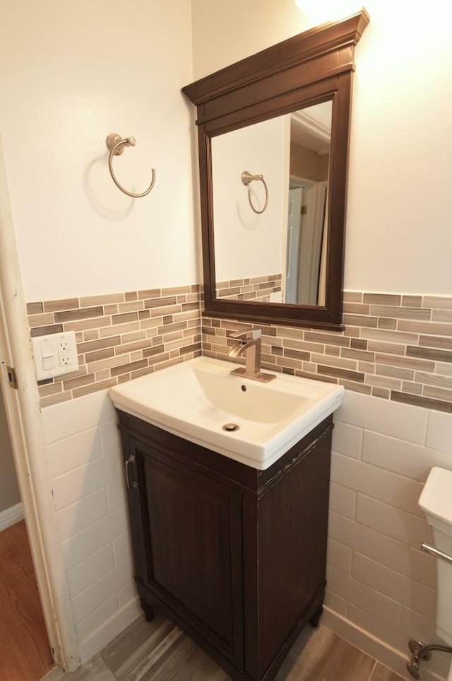 1227 S Harlem Ave Unit 511, Berwyn, IL 60402 - bathroom featuring vanity, wainscoting, tile walls, and wood finished floors