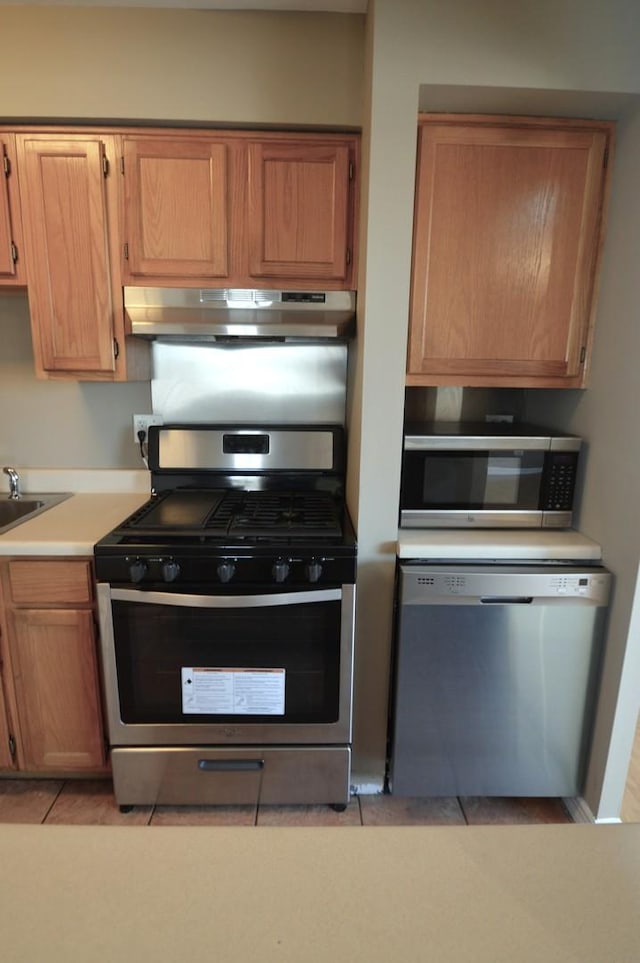 1227 S Harlem Ave Unit 511, Berwyn, IL 60402 - kitchen featuring under cabinet range hood, light tile patterned flooring, a sink, light countertops, and stainless steel appliances