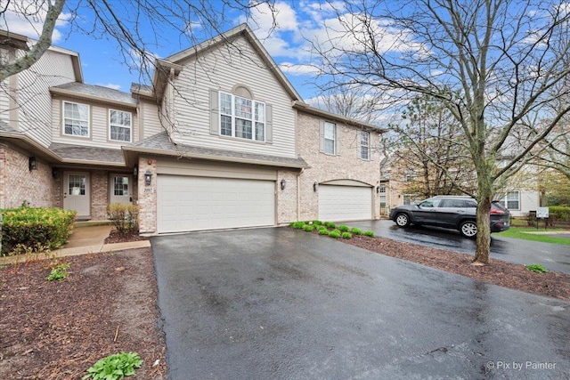 2097 Ivy Ridge Dr Unit 2097, Hoffman Estates, IL 60192 - view of property featuring aphalt driveway, brick siding, and a garage